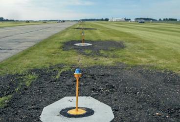 An LED taxiway light on the side of a runway