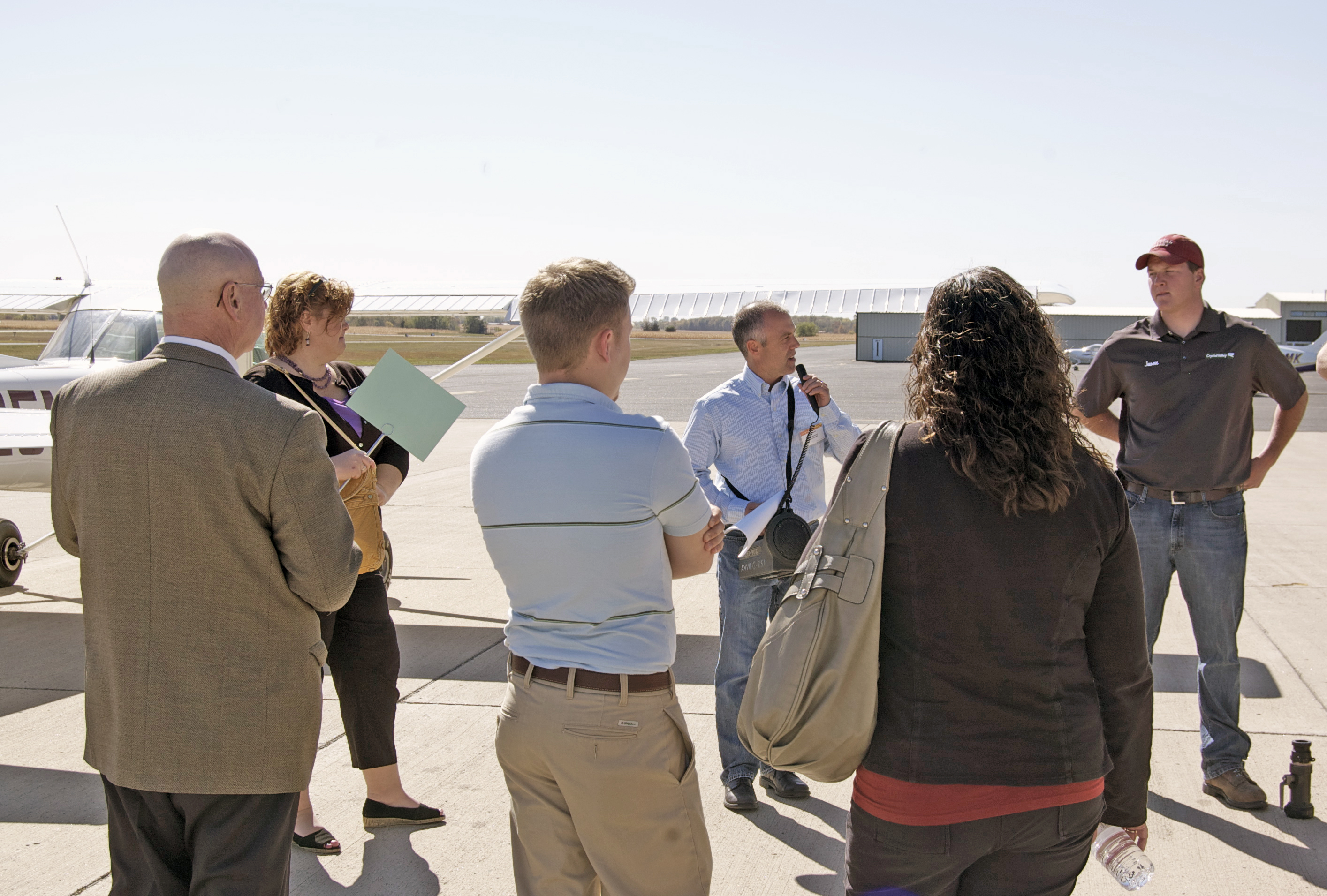 group of people outside on airport tour