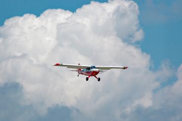 Small airplane in front of a cloud bank